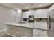 Modern kitchen with white cabinets, stainless steel appliances, and granite countertops at 3166 Via Da Vinci, Henderson, NV 89044