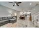 Open-concept living space with gray sofa, dining area, and modern kitchen, creating a seamless flow at 3166 Via Da Vinci, Henderson, NV 89044