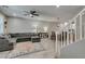 Open-concept living area with tile floors, a comfortable gray sectional sofa, and bright natural light at 3166 Via Da Vinci, Henderson, NV 89044