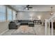 Inviting living room featuring a comfortable gray sectional, tile flooring, and bright natural light at 3166 Via Da Vinci, Henderson, NV 89044