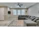 Relaxing living room area with a comfortable gray sectional, plantation shutters, and a mounted TV at 3166 Via Da Vinci, Henderson, NV 89044