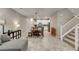 Open floor plan with modern kitchen, dining area, and staircase, perfect for entertaining at 3166 Via Da Vinci, Henderson, NV 89044