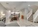 Open-concept living space with modern kitchen, dining area, and staircase, seamlessly connected at 3166 Via Da Vinci, Henderson, NV 89044