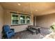 Covered outdoor patio with tile flooring, dining table set, and string lights, perfect for entertaining at 3166 Via Da Vinci, Henderson, NV 89044
