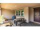 Cozy covered patio with stone pavers, outdoor dining furniture, and a grill for entertainment at 3166 Via Da Vinci, Henderson, NV 89044