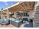 Outdoor space with covered patio, built in kitchen, outdoor seating and artificial turf at 3186 Lapis Beach Dr, Las Vegas, NV 89117