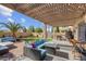 An entertainers backyard offering covered patio, outdoor seating and landscaped yard at 3186 Lapis Beach Dr, Las Vegas, NV 89117