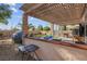 Inviting backyard with covered patio, outdoor seating, and professionally landscaped yard at 3186 Lapis Beach Dr, Las Vegas, NV 89117