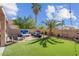 Relaxing backyard with manicured plants, turf and lounge seating around a fire pit at 3186 Lapis Beach Dr, Las Vegas, NV 89117