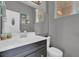 A cozy bathroom featuring gray walls, a sleek vanity, and beach-themed wall decor at 3186 Lapis Beach Dr, Las Vegas, NV 89117
