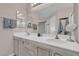 Bright bathroom featuring a double sink vanity with a large mirror and neutral color palette at 3186 Lapis Beach Dr, Las Vegas, NV 89117