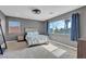 Large bedroom with window, ceiling fan, carpet floors, and neutral walls at 3186 Lapis Beach Dr, Las Vegas, NV 89117