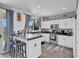 Modern kitchen boasts white cabinets, black countertops, and a breakfast bar at 3186 Lapis Beach Dr, Las Vegas, NV 89117