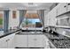 Modern kitchen with stainless steel appliances and large window for natural light at 3186 Lapis Beach Dr, Las Vegas, NV 89117