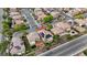 An eye-level aerial view highlights community, landscaping, solar panels, a pool, and outdoor living spaces at 3217 Palladio Ave, North Las Vegas, NV 89031