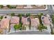 Aerial view showcases community landscaping, solar panels, swimming pool, and close proximity to surrounding neighborhood at 3217 Palladio Ave, North Las Vegas, NV 89031