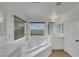 Relaxing bathroom with a large tub and natural light at 3217 Palladio Ave, North Las Vegas, NV 89031