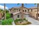 Stunning two-story home featuring a stone facade, a multi-car garage, and lush desert landscaping at 3217 Palladio Ave, North Las Vegas, NV 89031