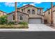 Charming two-story home with stone accents, neutral colors, a well-manicured yard, and an attached garage at 3217 Palladio Ave, North Las Vegas, NV 89031
