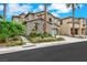 A front exterior view showcases a well-maintained yard, charming accents, and an attached two-car garage at 3217 Palladio Ave, North Las Vegas, NV 89031