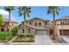 Two-story home with desert landscaping, stone accents, and a paved driveway at 3217 Palladio Ave, North Las Vegas, NV 89031