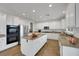 Bright kitchen features white cabinetry, a large island, granite countertops and stainless appliances at 3217 Palladio Ave, North Las Vegas, NV 89031