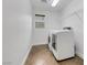 Functional laundry room featuring a washer and dryer with convenient shelving for storage at 3217 Palladio Ave, North Las Vegas, NV 89031