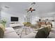 Spacious living room offers abundant seating, a ceiling fan, and an open concept design at 3217 Palladio Ave, North Las Vegas, NV 89031