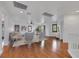 Bright living room featuring hardwood floors, white walls, neutral furniture, and a ceiling fan at 3217 Palladio Ave, North Las Vegas, NV 89031