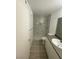 Bathroom featuring tile shower, shower niche, wood-look floors and vanity with sink at 3450 Erva St # 167, Las Vegas, NV 89117