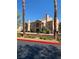Exterior view of a two-story condo featuring a red tile roof, a private balcony, and desert landscaping at 3450 Erva St # 167, Las Vegas, NV 89117