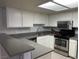 Spacious kitchen featuring white cabinets, light gray countertops, and stainless steel appliances at 3450 Erva St # 167, Las Vegas, NV 89117