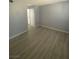 Living room featuring wood-look floors and neutral paint; doorway leads to kitchen at 3450 Erva St # 167, Las Vegas, NV 89117