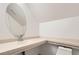 This bathroom features a bright white paint and a oval mirror at 3525 Tuscany Village Dr, Las Vegas, NV 89129