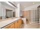 This primary bathroom features a soaking tub, glass block shower, and a long vanity at 3525 Tuscany Village Dr, Las Vegas, NV 89129