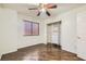 This bedroom offers hardwood floors, a ceiling fan, and a closet with built-in shelving at 3525 Tuscany Village Dr, Las Vegas, NV 89129