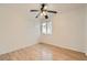 This bedroom features wood laminate floors, and a window with blinds at 3525 Tuscany Village Dr, Las Vegas, NV 89129