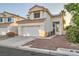 Charming two-story home featuring a two-car garage, desert landscaping, and a warm, inviting entrance at 3525 Tuscany Village Dr, Las Vegas, NV 89129