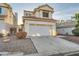Inviting two-story home with a two-car garage and well-maintained desert landscaping in a residential area at 3525 Tuscany Village Dr, Las Vegas, NV 89129