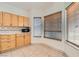 Kitchen area featuring light wood cabinets, tiled countertops, and lots of natural light at 3525 Tuscany Village Dr, Las Vegas, NV 89129