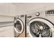 This is a laundry room featuring a countertop, cabinets, a washer and a dryer at 3525 Tuscany Village Dr, Las Vegas, NV 89129