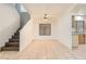 Living area with tile floors, neutral walls, ceiling fan, and stairs to second floor at 3525 Tuscany Village Dr, Las Vegas, NV 89129