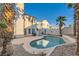A private backyard featuring a kidney-shaped swimming pool surrounded by desert landscaping and mature palm trees at 3525 Tuscany Village Dr, Las Vegas, NV 89129