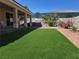 Spacious backyard featuring artificial turf and covered patio perfect for outdoor entertaining at 3567 Cottage Stream Ct, Laughlin, NV 89029