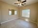 Well-lit bedroom with neutral walls, ceiling fan, and tiled floor at 3567 Cottage Stream Ct, Laughlin, NV 89029