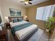 Well-lit bedroom with a calm vibe, featuring a queen-sized bed and scenic wall art at 3567 Cottage Stream Ct, Laughlin, NV 89029