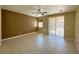 Bedroom with tile flooring, ceiling fan, and sliding glass door access to the backyard at 3567 Cottage Stream Ct, Laughlin, NV 89029