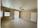 Comfortable bedroom features a ceiling fan, tile flooring and natural light from the window at 3567 Cottage Stream Ct, Laughlin, NV 89029