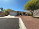 Single-story house showcasing desert landscape and a two-car garage at 3567 Cottage Stream Ct, Laughlin, NV 89029