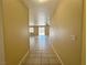 Hallway with tile floor leading to an open living space with fan at 3567 Cottage Stream Ct, Laughlin, NV 89029